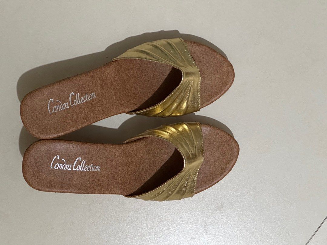 A pair of gold colored wedge heels Women s Fashion Footwear