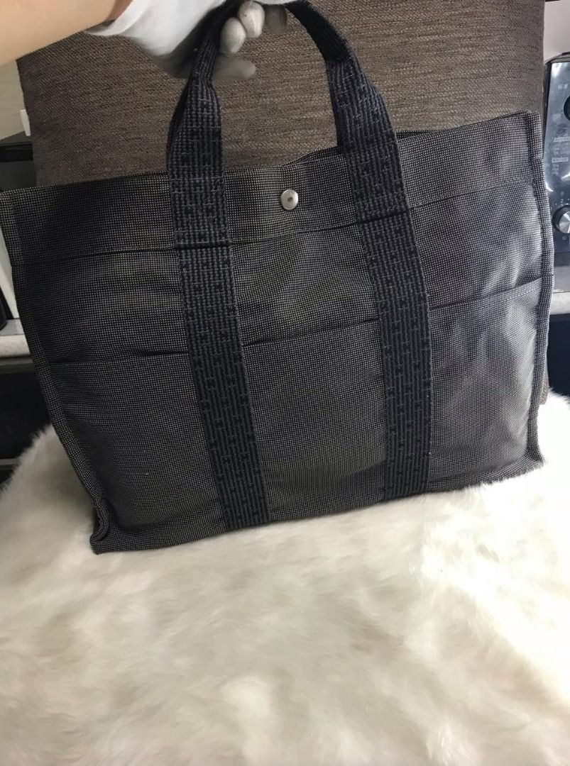 HERMES Herline bag with Cadena PadLock & Key (Category: Luxury Bags & Wallets) located in Quezon City. Submitted by rendez-vous20 (Listing ID 1269242027, Image 3). Description: Herline bag Hermes tote grey/black canvas logo-patterned strap appliqué concealed press-stud fastening top zip fastening two top handles three front patch pockets canvas lining silver-tone hardware rectangle body HERMES Cadena PadLock & Key & Leash Silver No.107 Like new N