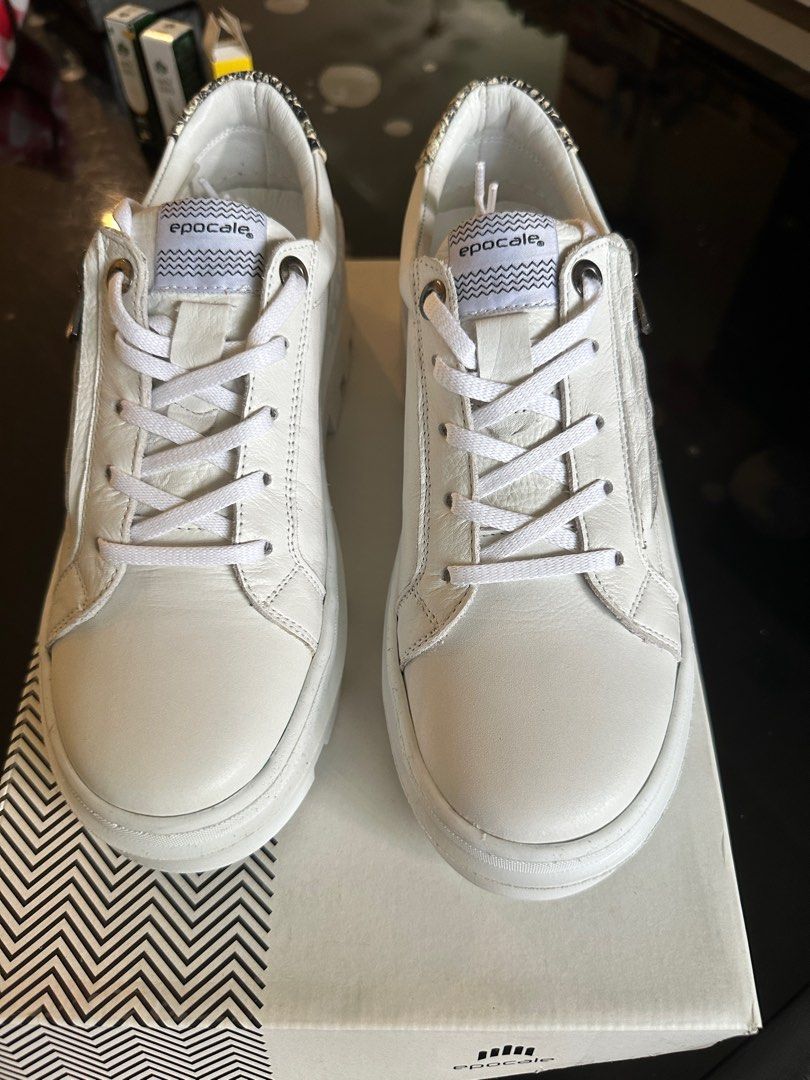White sneakers with deals numbers on the side