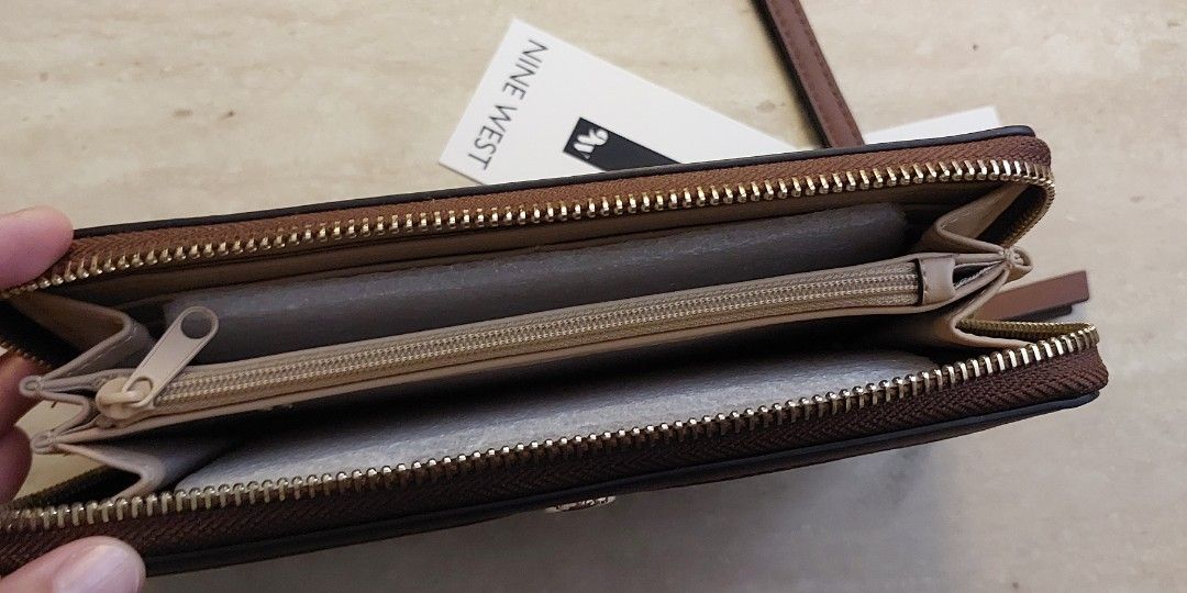 Nine West Wallet with lanyard (Category: Luxury Bags & Wallets) located in Pasig City. Submitted by tomoegozen_0925 (Listing ID 1275236182, Image 2). Description: Fits 6in phone. 12 card slots. Payment via gcash or UB/BPI bank transfer..