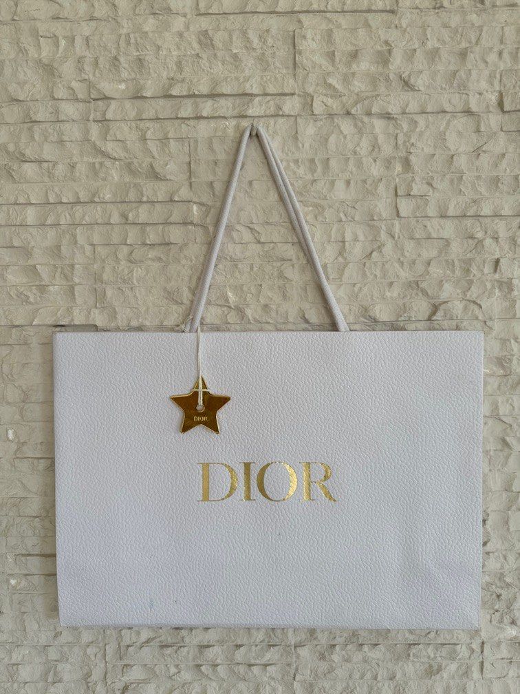 Dior Paperbag with Dior Star Charm Medium (Category: Luxury Accessories) located in San Fernando. Submitted by mnlt_o (Listing ID 1275464961, Image 1). Description: Authentic From Dior, Paris See photos for condition OAD: 30 L x 42 W x 13 D cm Price: 1,800 + 250 shipping Location: San Fdo Pamp..