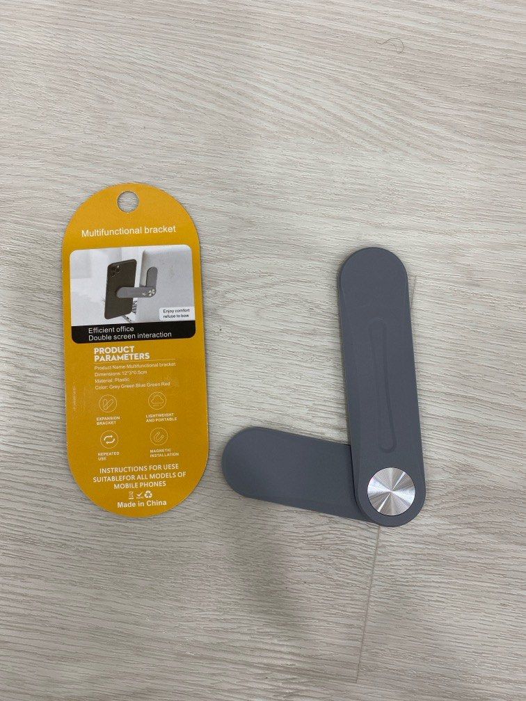 Multi-functional bracket (Category: Other Mobile & Gadget Accessories) located in Singapore. Submitted by turtle2001 (Listing ID 1275621677, Image 1). Description: Can be used to stick on your laptop and hook your phone to it by the side for a second screen. Wonderful tool to prevent neck ache during work :).