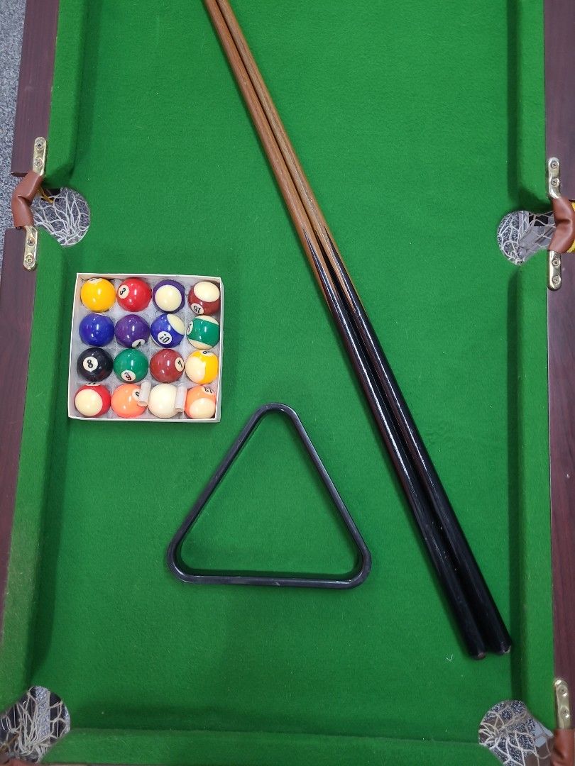 Foldable Mini Pool Table (Category: Billiards & Bowling) located in Singapore. Submitted by woodworkz (Listing ID 1270192584, Image 1). Description: Sparingly used. Has some scratches and dinks from moving in storage. comes with two cues, triangle and balls..