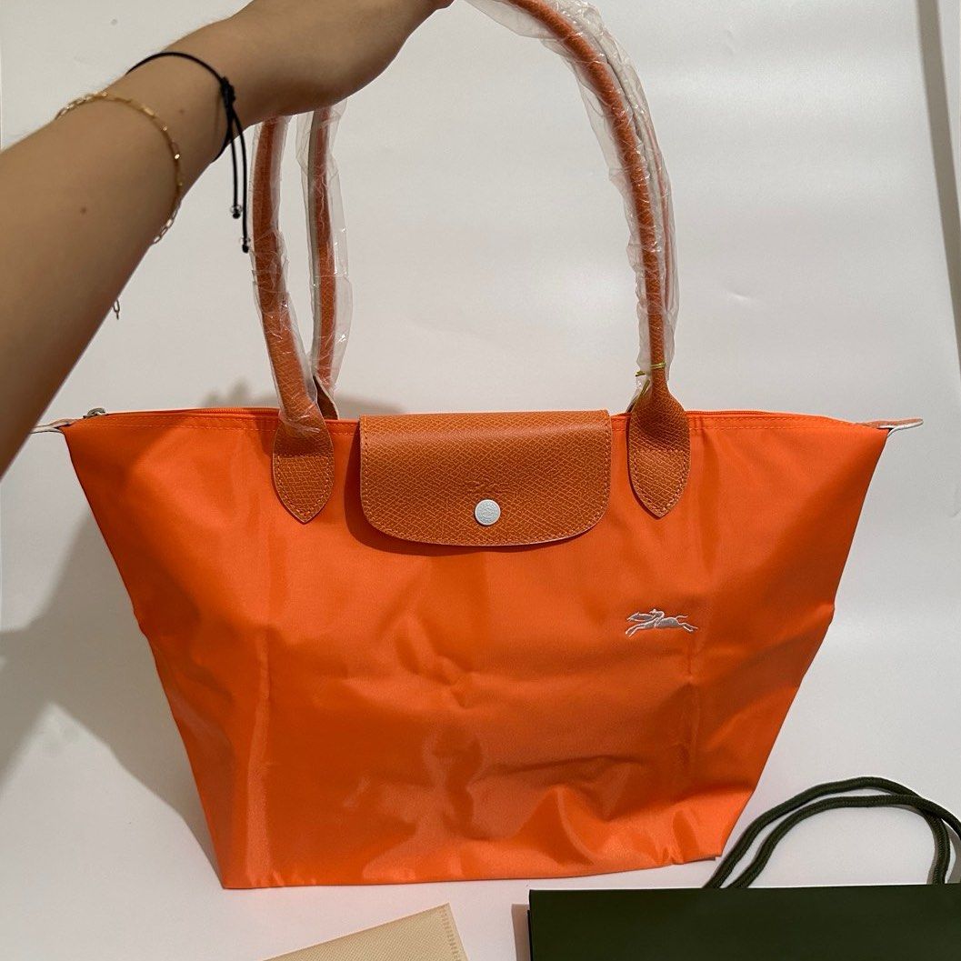 Longchamp Club Long Handle (Category: Luxury Bags & Wallets) located in Makati City. Submitted by lux.mariah (Listing ID 1270234323, Image 1). Description: Guaranteed Auth 💗 Longchamp Club Orange color Brand new Complete inclusions Can fit laptop / ipad Very spacious Courier lalamove j&t and LBC.