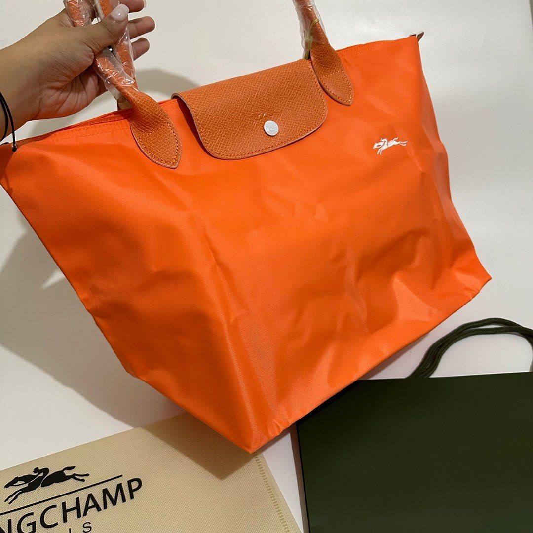 Longchamp Club Long Handle (Category: Luxury Bags & Wallets) located in Makati City. Submitted by lux.mariah (Listing ID 1270234323, Image 2). Description: Guaranteed Auth 💗 Longchamp Club Orange color Brand new Complete inclusions Can fit laptop / ipad Very spacious Courier lalamove j&t and LBC.