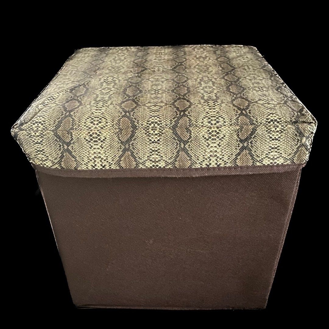 OTTOMAN - SMALL STORAGE STOOL - MULTIFUNCTIONAL SNAKE PRINT FOLDABLE STORAGE STOOL IN BROWN (Category: Storage Boxes & Baskets) located in Taguig. Submitted by thatswhatshesells (Listing ID 1270354677, Image 1). Description: - Brand New - Snake Print Small Storage Bin/ Stool - Ottoman - Multifunctional - Measures: 30x30x30 - Material: Leather Snake Cover; Canvas Bottom - MOP: BDO; GCash - Delivery c/o Buyer - No Return; No Exchange.