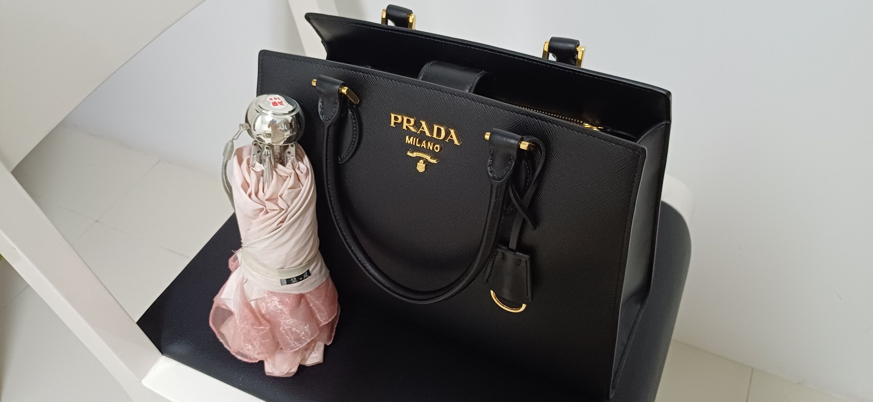 Prada paradigme bag price deals