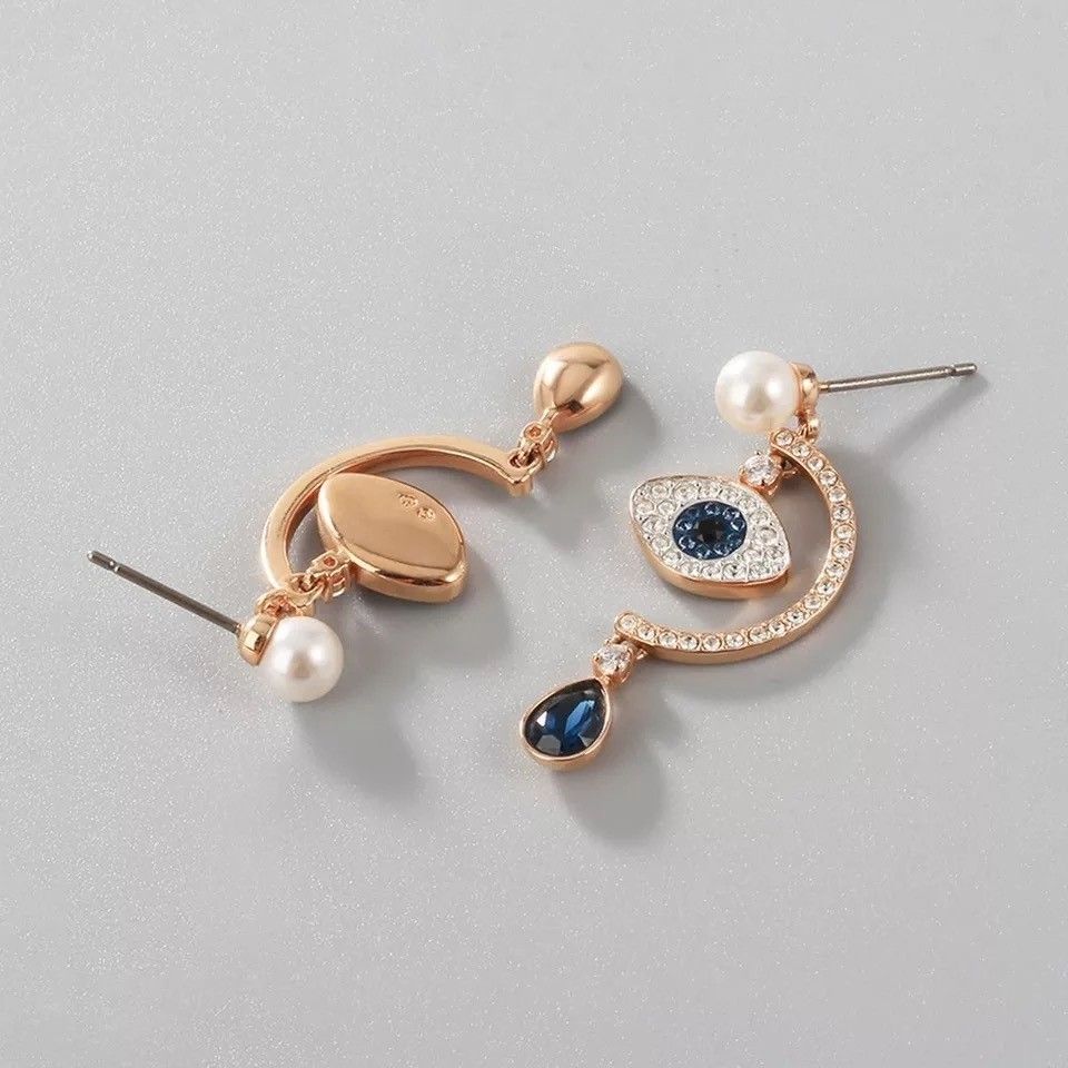 Swarovski duo shop evil eye earrings
