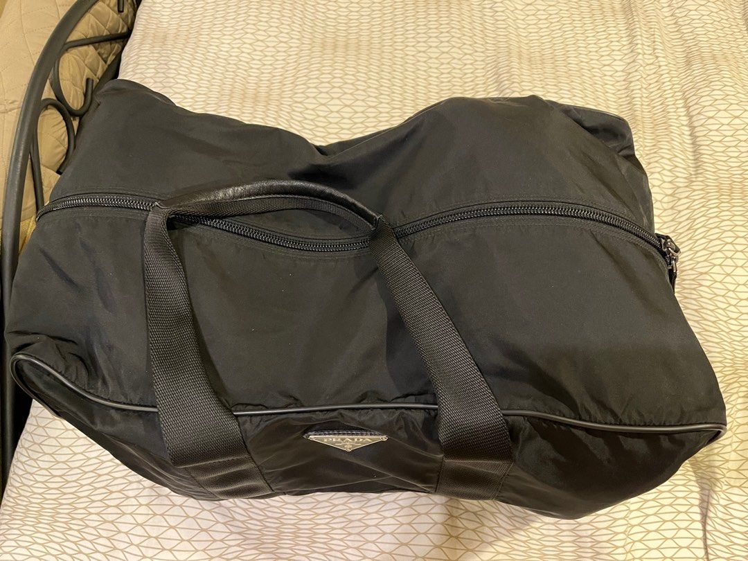 Prada Travel Bag (Category: Luxury Bags & Wallets) located in Mandaluyong City. Submitted by kqloset (Listing ID 1214908065, Image 2). Description: Size: 52cm x 30cm x 30cm No strap One snap button missing (pls see photo).