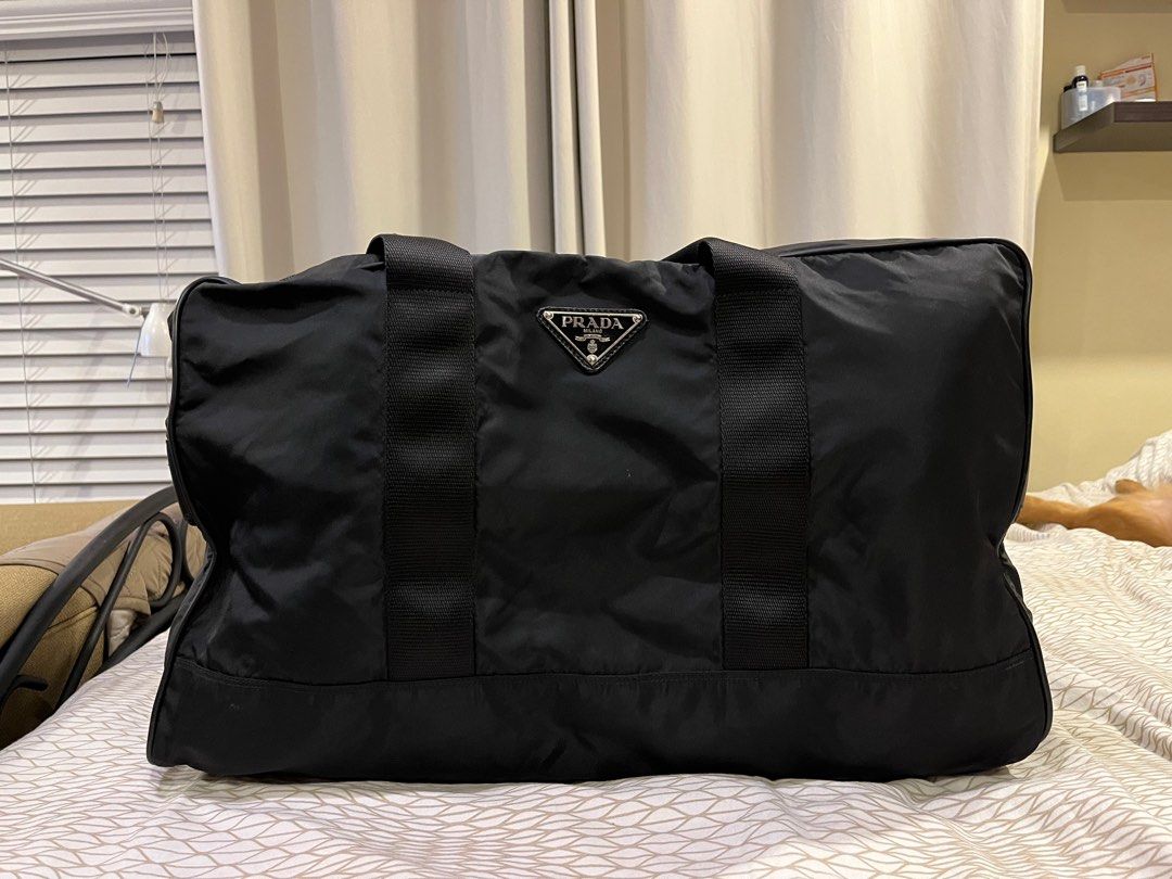 Prada Travel Bag (Category: Luxury Bags & Wallets) located in Mandaluyong City. Submitted by kqloset (Listing ID 1214908065, Image 1). Description: Size: 52cm x 30cm x 30cm No strap One snap button missing (pls see photo).