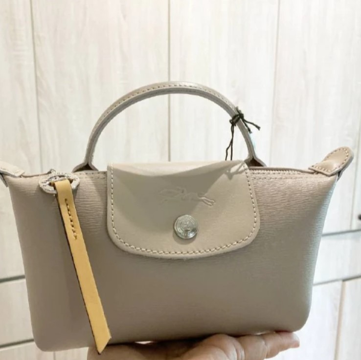 This color is Taupe! Le Pliage Coated canvas city pouch. Dm to