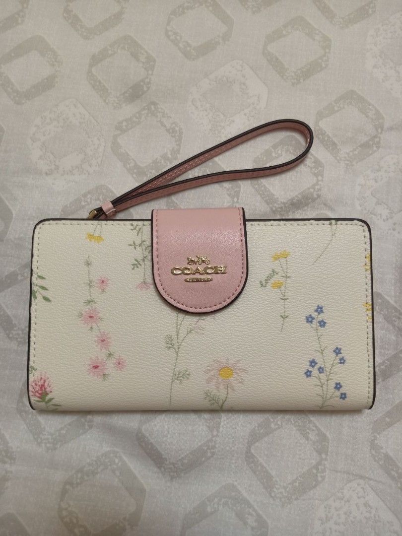 Coach Tech Phone Wallet with Spaced Wildflower (Category: Wallets & Card holders) located in Noveleta. Submitted by emilylestrange (Listing ID 1216516962, Image 1). Description: Brandnew authentic Coach wallet/wristlet with drawstring pouch bag, box and paper bag..