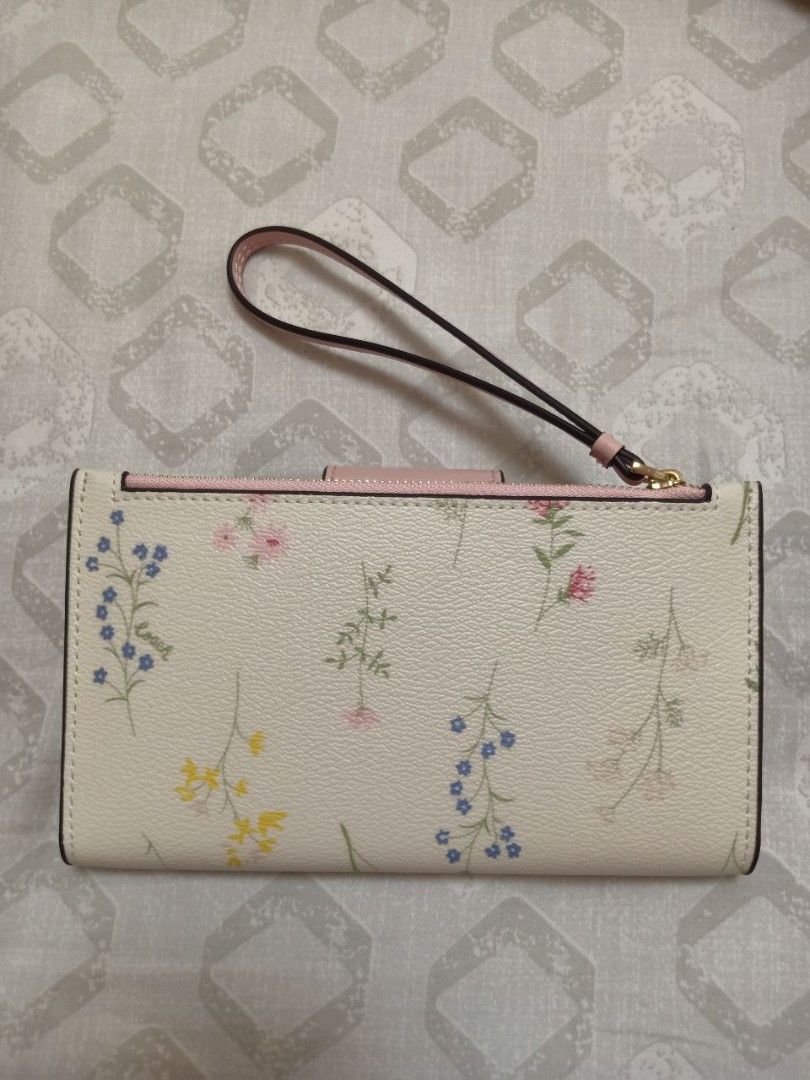 Coach Tech Phone Wallet with Spaced Wildflower (Category: Wallets & Card holders) located in Noveleta. Submitted by emilylestrange (Listing ID 1216516962, Image 2). Description: Brandnew authentic Coach wallet/wristlet with drawstring pouch bag, box and paper bag..