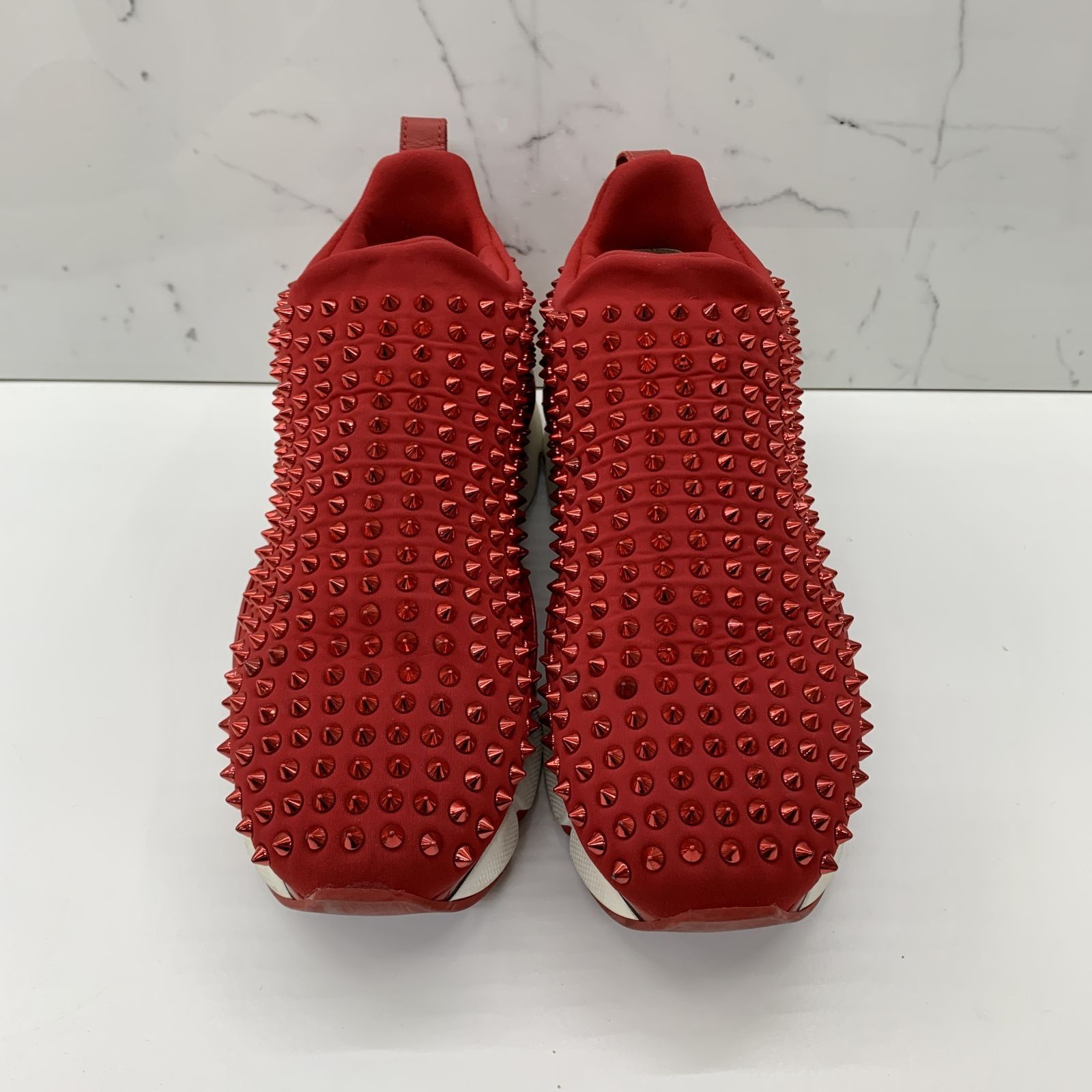 Red studded louboutin sneakers store