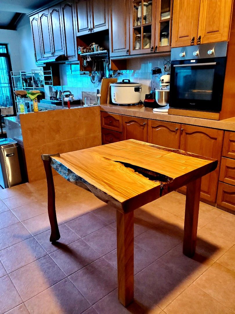 Hard to describe! Yes, this table has one foot made from an actual wood