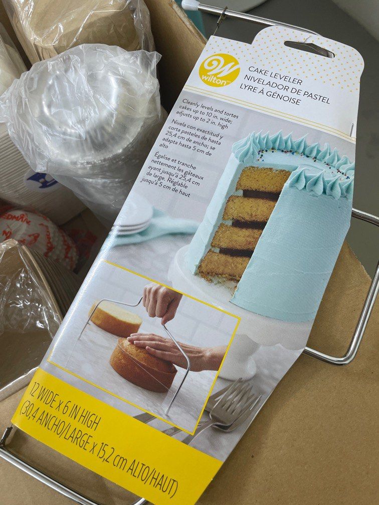 Assorted items (Category: Bakeware) located in Singapore. Submitted by tan.a.alia (Listing ID 1217629843, Image 2). Description: Comes with - 300 muffin/bun non stick cups, - Wilton cake leveler - 3 packs of piping bag .