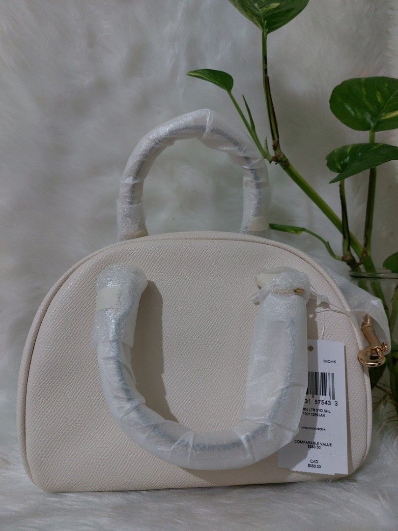 Authentic Coach Sydney Satchel (Category: Luxury Bags & Wallets) located in Quezon City. Submitted by KatieAnn (Listing ID 1217781358, Image 3). Description: 🇺🇲💯 New/Authentic/Original💯🇺🇲 Color: Gold/Chalk Material: Crossgrain Leather 👜Inside multifunction pocket 👜Zip closure, fabric lining 👜Handles with 2.75" drop 👜Detachable strap with 22.5" drop for shoulder or crossbody wear 📐Size: 8"L x 6"H x 5"W ✅️ USA-bought ✅️ Actual pictures p