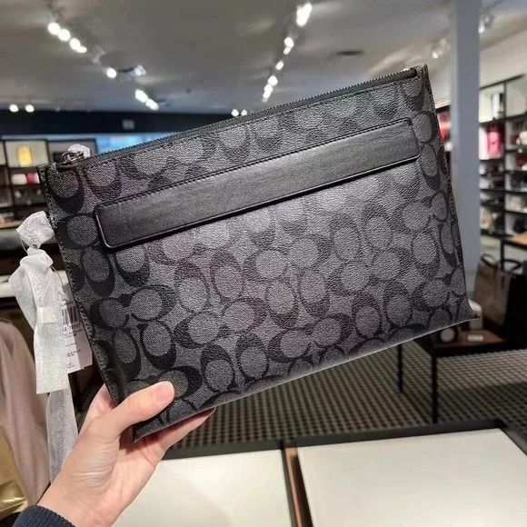 Coach carryall pouch in signature canvas online