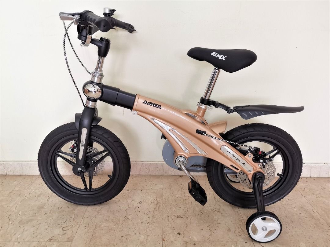 Child Bicycle (PN025) [14 inch Wheel Size] [Retractable Frame] [Foldable Handlebar] [Embedded Clock] (Category: Bicycles) located in Singapore. Submitted by gstrade (Listing ID 1213275574, Image 3). Description: Child Bicycle (PN025) - Free bell, pump, and fender - Color option: gold - Brand new - Single-speed bicycle - Retractable frame - Foldable handlebar - Embedded clock - Double disc brakes - Integrated wheels - Frame material: premium magne