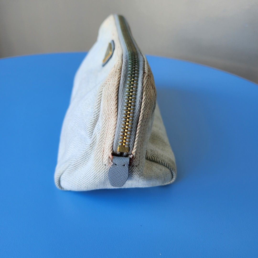 Authentic Prada denim pouch (Category: Luxury Bags & Wallets) located in Pasig City. Submitted by kitsch_closet (Listing ID 1213591235, Image 2). Description: Authentic Preloved Prada denim pouch with slight discoloration minor signs of use.