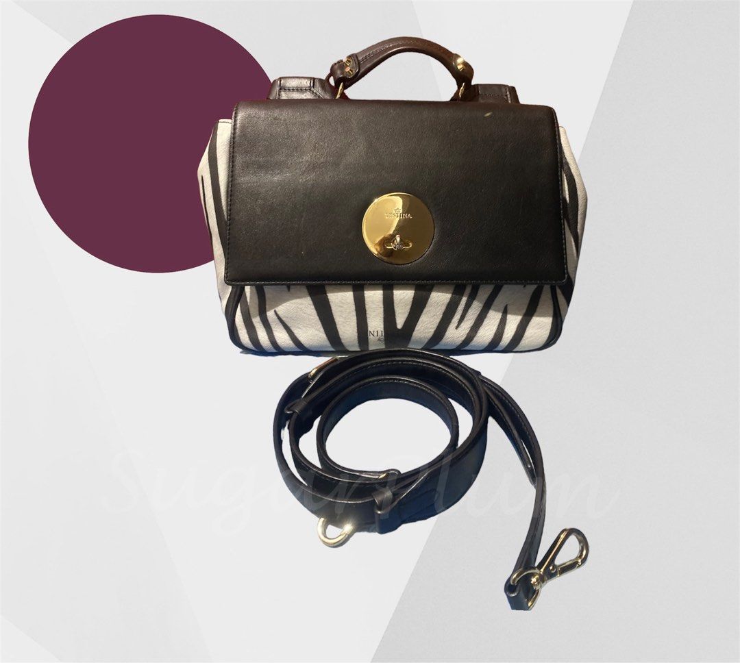 j.estina Leto Zebra print (Category: Luxury Bags & Wallets) located in Cavite. Submitted by sugarplum_24 (Listing ID 1214159769, Image 1). Description: Brand: J.estina / Jestina Design: Leto line (limited edition / rare) Zebra print Style: 2 way, handbag and sling Issue: Normal signs of use (pressmarks/scratches sa leather kya bagsak presyo) Gold pa ung metal (signs of use lng din) From 1500 to 1350 ❗❗❗PLEASE READ 🌸This item is preloved. Signs o