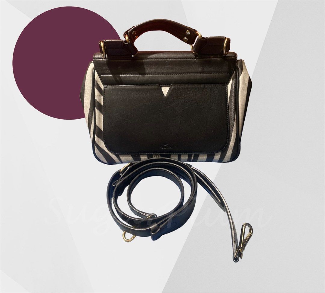 j.estina Leto Zebra print (Category: Luxury Bags & Wallets) located in Cavite. Submitted by sugarplum_24 (Listing ID 1214159769, Image 2). Description: Brand: J.estina / Jestina Design: Leto line (limited edition / rare) Zebra print Style: 2 way, handbag and sling Issue: Normal signs of use (pressmarks/scratches sa leather kya bagsak presyo) Gold pa ung metal (signs of use lng din) From 1500 to 1350 ❗❗❗PLEASE READ 🌸This item is preloved. Signs o