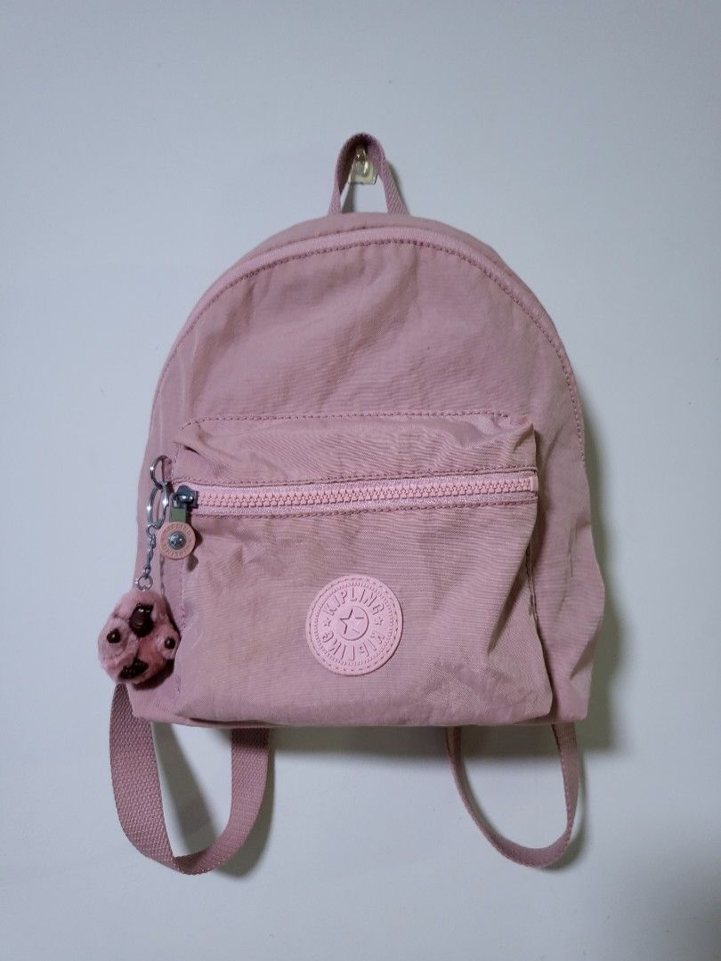 KIPLING backpack (Category: Backpacks) located in Singapore. Submitted by fleurj48 (Listing ID 1214306448, Image 5). Description: Preloved Kipling backpack in bold blush /pink for sale Good condition cos hardly used - Nylon - Dimensions: 8.75"L x 10.75"Н 3.75"D Weight: 0.53 lbs Volume: 6L Top carry handle Adjustable backpack straps Front zip pocket Internal slip pocket Monkey keychain Imported Pm for more details Deal at Marine Parade paynow only