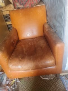 Leather single arm chair & poof all in good condition made to look rustic