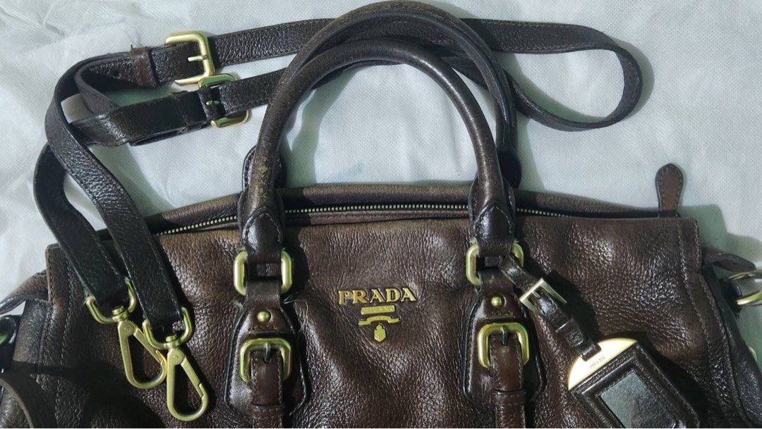 Prada 2way bag (Category: Luxury Bags & Wallets) located in Mandaluyong City. Submitted by amvvg (Listing ID 1219973357, Image 2). Description: Prada 2way strap Dark brown with gold logo Gold hardware Deer leather Guaranteed authentic P12,000 For pickup from Mandaluyong c/o buyer.