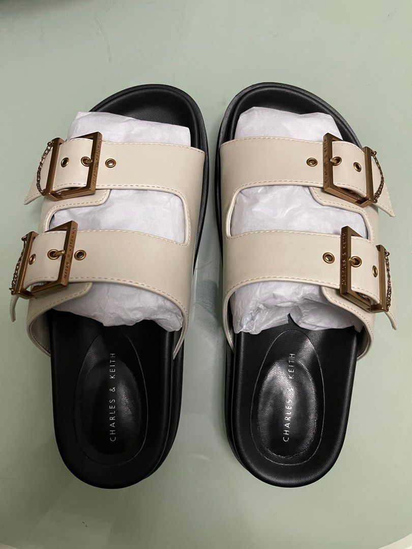 Charles & Keith Chain-Link Buckled Slide Sandals (Category: Flats & Sandals) located in Taguig. Submitted by fftshp (Listing ID 1220237004, Image 1). Description: Original Charles & Keith Sandals (Ordered on Official Website) Size: 36 Color: Chalk RFS: Too small for me Note: Used twice, with minimal side creases due to usage. Slightly negotiable..