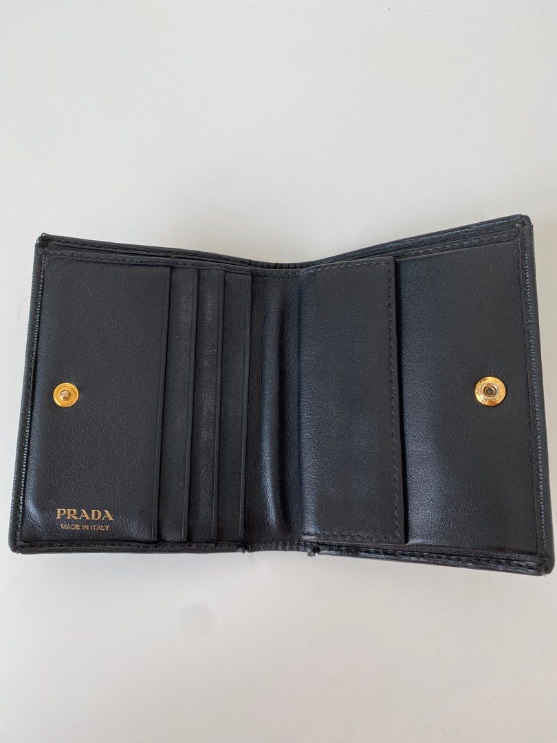AUTHENTIC PRADA Vitello Move Compact Wallet (Category: Luxury Bags & Wallets) located in Taguig. Submitted by acby.shop (Listing ID 1220209817, Image 3). Description: 100% AUTHENTIC Well-used (condition: 7/10) Color: Nero (black) Usual signs of use/ wear & tear Bought from New York back in 2017 Comes with boxes & authenticity card RFS: Decluttering.