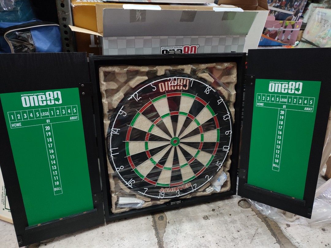 Dartboard Set with Cabinet (Category: Other Sports Equipment and Supplies) located in Manila. Submitted by min_yoongi (Listing ID 1220576203, Image 2). Description: Available ✓ ONE 80 PRO ACHIEVER DART SET INCLUDED: - Quality Wooden Cabinet - 18" x 1-1/2" Bristle Dartboard - 1 set of 20g Tungsten plated dart pin - 2 Chalks & 1 Eraser Pm for inquiries..