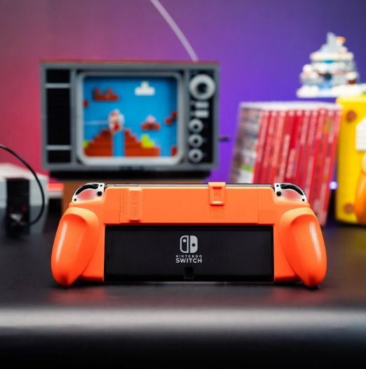 Skull & Co Limited Edition NeoGrip GameCube Orange for Nintendo Switch and Switch OLED (Category: Cases & Covers) located in Las Pinas. Submitted by techsmartph (Listing ID 1220749883, Image 3). Description: * One grip, two consoles - fits both Nintendo SWITCH OLED and OG SWITCH. * Ergonomic design - allows hours of play without fatigue. * Access the kickstand - never hold back your console. * Interchangeable grips - 3 different designs to fit al