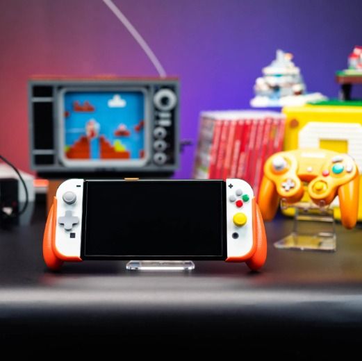Skull & Co Limited Edition NeoGrip GameCube Orange for Nintendo Switch and Switch OLED (Category: Cases & Covers) located in Las Pinas. Submitted by techsmartph (Listing ID 1220749883, Image 2). Description: * One grip, two consoles - fits both Nintendo SWITCH OLED and OG SWITCH. * Ergonomic design - allows hours of play without fatigue. * Access the kickstand - never hold back your console. * Interchangeable grips - 3 different designs to fit al