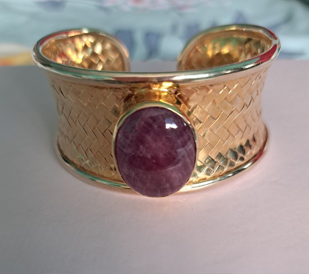 Ruby cuff bangle (Category: Precious Stones) located in Singapore. Submitted by mun_kat (Listing ID 1221302597, Image 2). Description: Brand new untreated NATURAL Cabochon Ruby on 925 silver woven bangle plated in yellow gold Ruby shape: Cabochon oval size of Ruby: Weight of Ruby: Approximately 8 carat Bangle: Adjustable cuff bangle; any wrist size able to wear Metal purity: 915 sterling silver plated in yellow gold 5 micron; Colour doesn't tarni