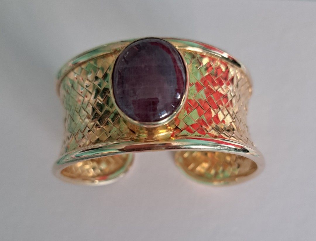 Ruby cuff bangle (Category: Precious Stones) located in Singapore. Submitted by mun_kat (Listing ID 1221302597, Image 1). Description: Brand new untreated NATURAL Cabochon Ruby on 925 silver woven bangle plated in yellow gold Ruby shape: Cabochon oval size of Ruby: Weight of Ruby: Approximately 8 carat Bangle: Adjustable cuff bangle; any wrist size able to wear Metal purity: 915 sterling silver plated in yellow gold 5 micron; Colour doesn't tarni