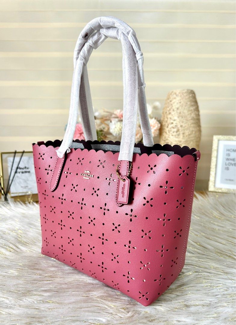 Coach Mini Gallery (Category: Luxury Bags & Wallets) located in Mandaluyong City. Submitted by shop_0n_the_spot (Listing ID 1221522436, Image 2). Description: City Mini Tote Color - Rouge Product Details Textured leather and smooth leather Inside multifunction pocket Dogleash clip closure, fabric lining Handles with 7” drop 9” (L) x 8” (H) x 4 1/4” (W) Style No. CA199 💯% GUARANTEED ORIGINAL & BRAND NEW. 🚛 OnH@nd and Ready to Ship 🏷 Inclusions: