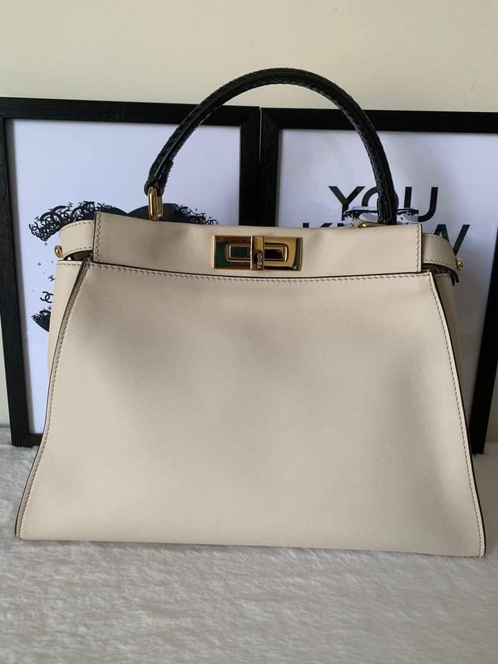 Fendi Peekaboo Medium w/ Monster Eyes Interior (Category: Luxury Bags & Wallets) located in Manila. Submitted by bagislifeshop (Listing ID 1221830920, Image 2). Description: ▪️Fendi Peekaboo Medium w/ Monster Eyes Interior￼ Bag▪️ ☑️Available in Pampanga ✅Condition: 8.8/10 ✅Material: Python leather, calf leather ✅Colour: Ivory in GHW, black python top handle ✅Inclusions: dustbag, raincoat, cards and python strap.