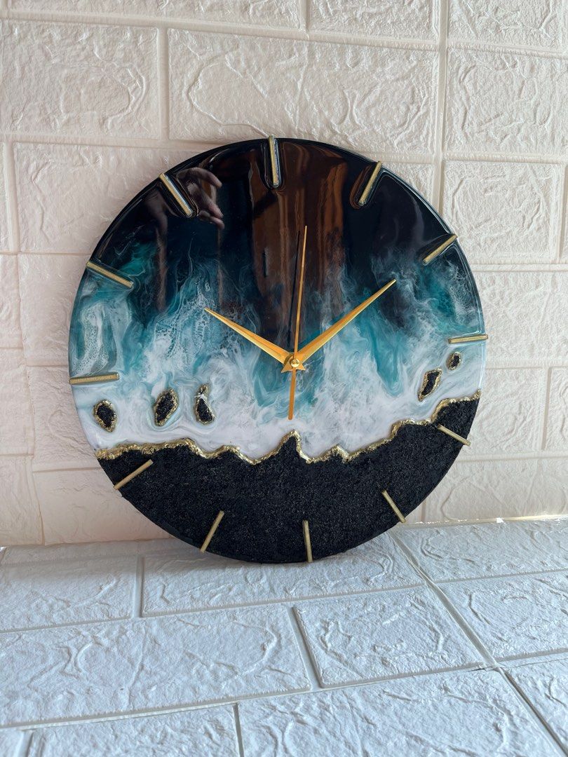wall clock (Category: Clocks) located in Singapore. Submitted by gee68 (Listing ID 1222176830, Image 2). Description: Resin art seascape wall clock with texture in black and white with golden hands size: 30cm diameter the clock is made with resin and pigments on wood panel embellished with glass crystals ..its a beautiful piece of art other needle options available can be made with silver hands & other colors too preorder...ready in 3-4 days cloc