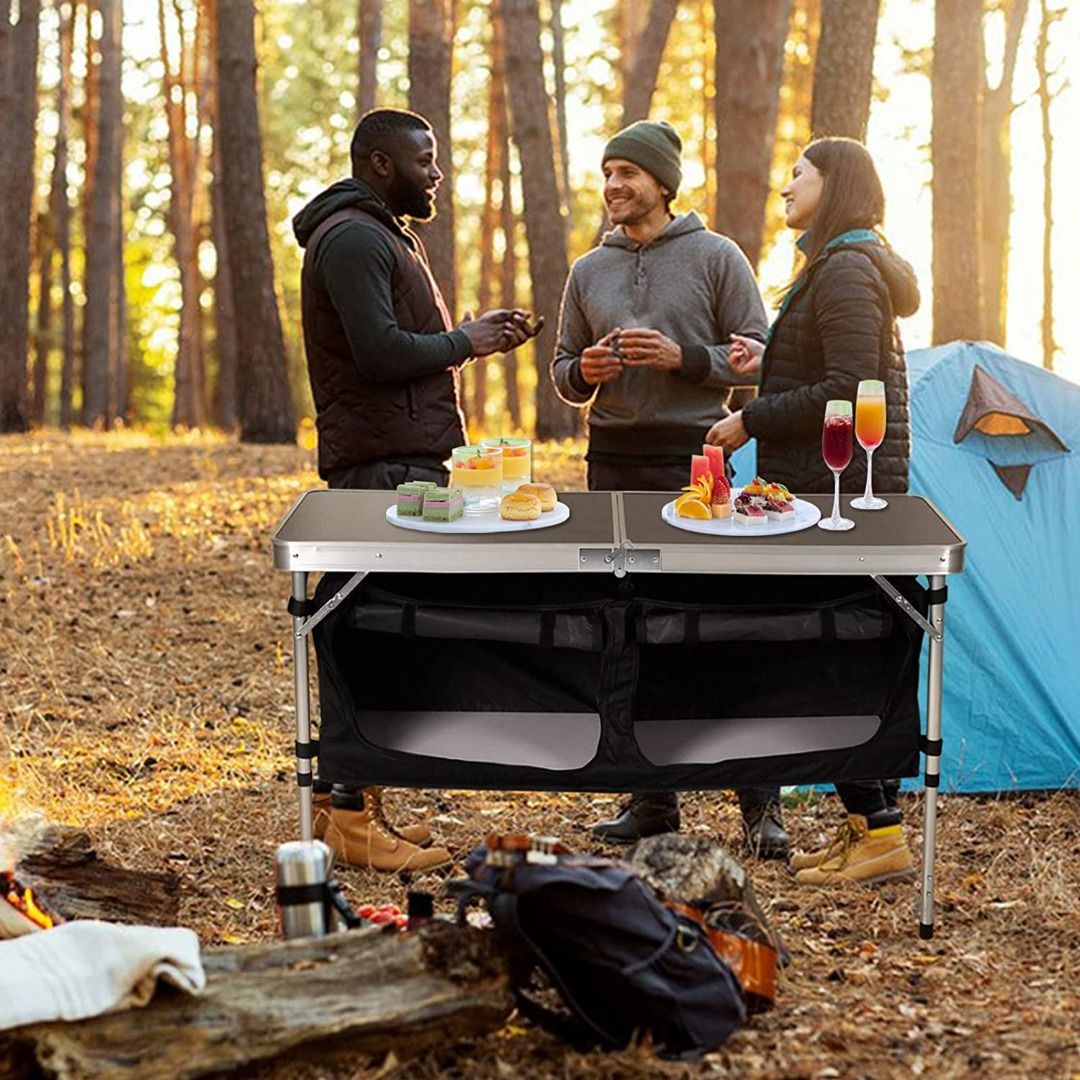 Folding camping table outlet with adjustable legs