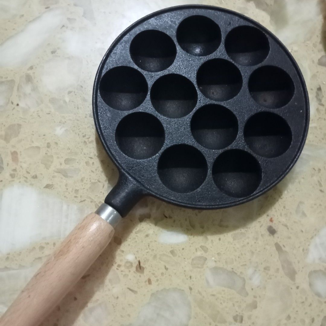 CAST IRON TAKOYAKI PAN (Category: Cookware & Accessories) located in Malolos. Submitted by laxada_japan.surplus (Listing ID 1222665061, Image 1). Description: 🥳🥳🥳FOR SALE!!!🎉🎉🎉 TAKOYAKI Cast iron Good as new 12 holes wooden handle.