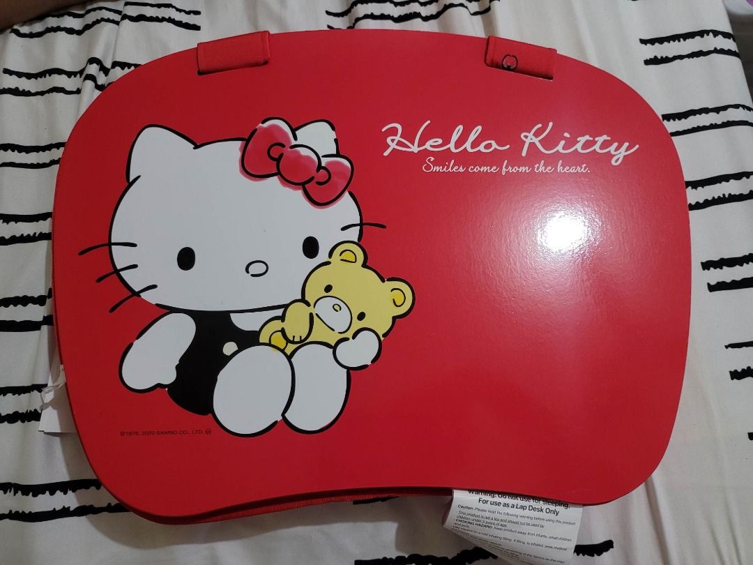 Hello Kitty Portable Lap Desk (Category: Laptop Bags & Sleeves) located in Marikina City. Submitted by mypeculiarcloset (Listing ID 1222689865, Image 1). Description: Hello Kitty Portable Lap Desk BNWT Perfect for everyone working from home these days, this Hello Kitty laptop cushion is a total essential. The flat and elevated surface makes it comfortable to type on the couch. Finished with a top handle, it’s easy to carry and store once you cloc