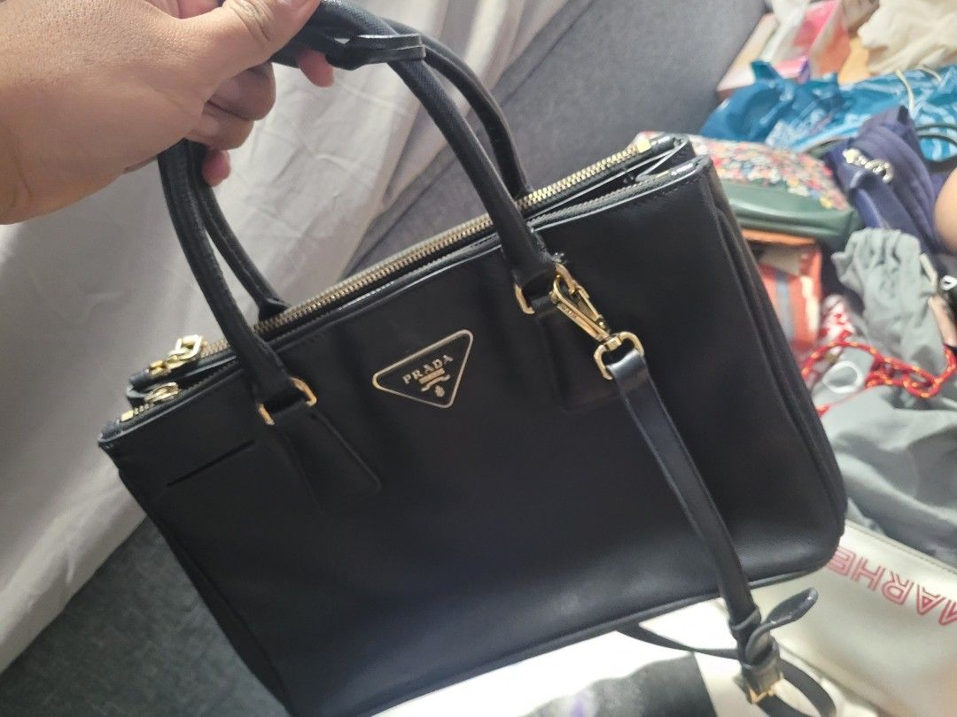 Prada (Category: Cross-body Bags) located in Singapore. Submitted by baygoni (Listing ID 1222693733, Image 3). Description: view pic for reference. defect button on one side as posted in the picture. clearing it out. cant confirm its authenticity hence, the stated price..