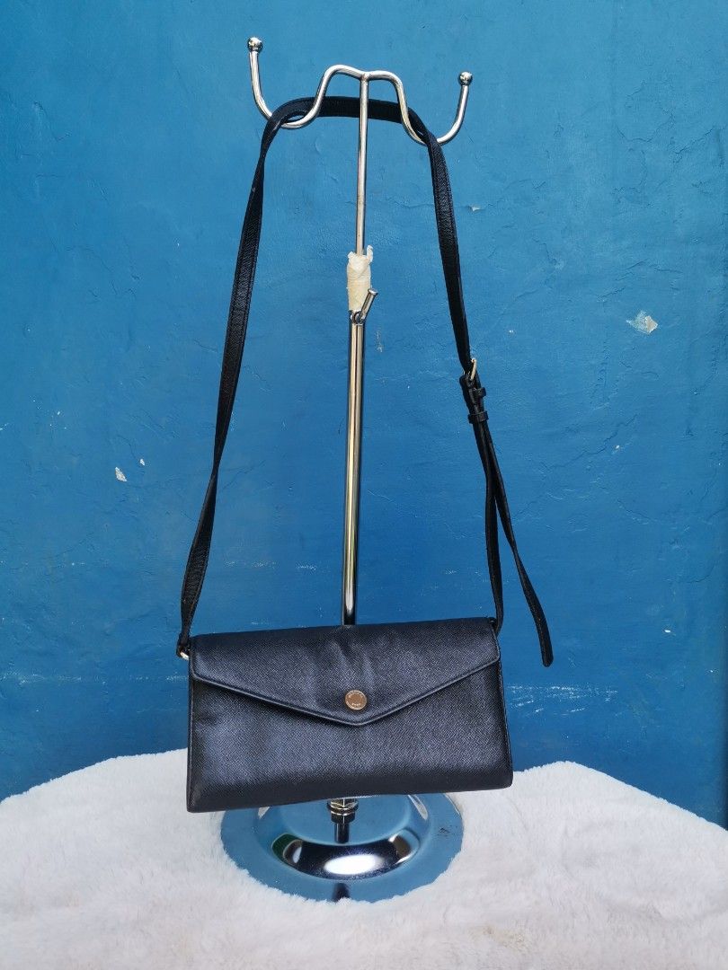 Saffiano MK Wallet Slingbag (Category: Luxury Bags & Wallets) located in Cagayan de Oro. Submitted by pastel829 (Listing ID 1222616125, Image 1). Description: ‼️MARKED DOWN ‼️ 🔥HOT SALE 🔥 Michael Kors Saffiano Leather Wallet Sling bag ✅Pre-owned. Personally bought abroad . ✅Overall condition : 8/10. Slightly tarnish on the MK button logo. Gold chain still shiny pa nman. Needs polish if u want. ✅NO visible flaws. NO rubs on the bottom edges or l