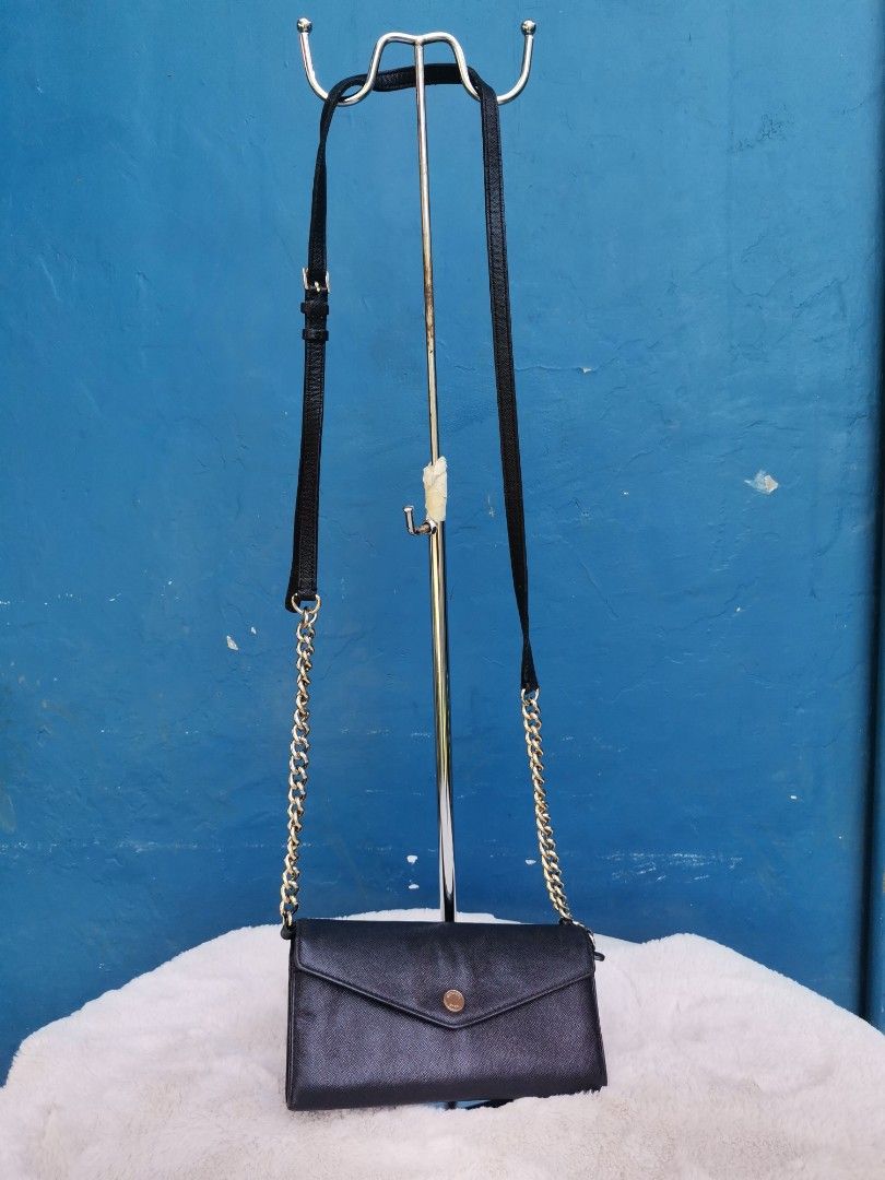 Saffiano MK Wallet Slingbag (Category: Luxury Bags & Wallets) located in Cagayan de Oro. Submitted by pastel829 (Listing ID 1222616125, Image 2). Description: ‼️MARKED DOWN ‼️ 🔥HOT SALE 🔥 Michael Kors Saffiano Leather Wallet Sling bag ✅Pre-owned. Personally bought abroad . ✅Overall condition : 8/10. Slightly tarnish on the MK button logo. Gold chain still shiny pa nman. Needs polish if u want. ✅NO visible flaws. NO rubs on the bottom edges or l