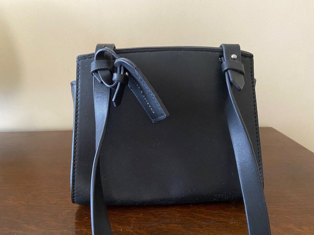 Charles & Keith Black Bag (Category: Cross-body Bags) located in Marikina City. Submitted by beinginspace (Listing ID 1222897047, Image 3). Description: Pu leather with felt flap top Rarely used but flaws and creases from storage Flaws include pu leather peeling. All shown in pictures 20 (w) x 15 (l) x 10 (d) cm.
