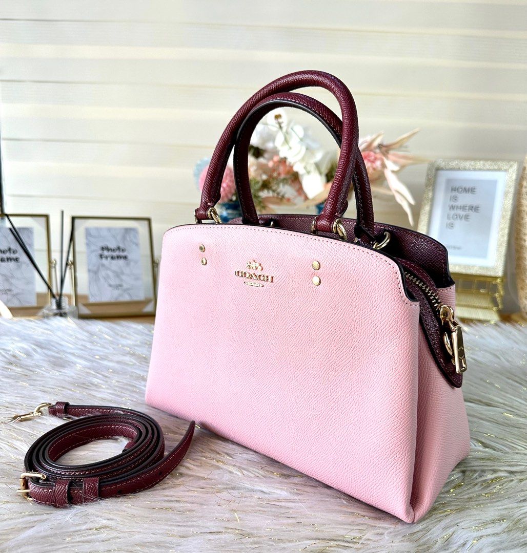 Coach Mini Lillie Carryall (Category: Luxury Bags & Wallets) located in Mandaluyong City. Submitted by shop_0n_the_spot (Listing ID 1223119208, Image 2). Description: Mini Lillie Carryall Color : Powder Pink/Wine Multi Product Details: Crossgrain leather Center zip compartment Snap closure, fabric lining Handles with 4 1/4” drop Outside open pocket Detachable strap with 21 1/2” drop for shoulder or crossbody wear Four protective feet at base 10 1
