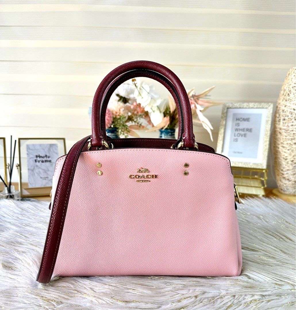 Coach Mini Lillie Carryall (Category: Luxury Bags & Wallets) located in Mandaluyong City. Submitted by shop_0n_the_spot (Listing ID 1223119208, Image 1). Description: Mini Lillie Carryall Color : Powder Pink/Wine Multi Product Details: Crossgrain leather Center zip compartment Snap closure, fabric lining Handles with 4 1/4” drop Outside open pocket Detachable strap with 21 1/2” drop for shoulder or crossbody wear Four protective feet at base 10 1