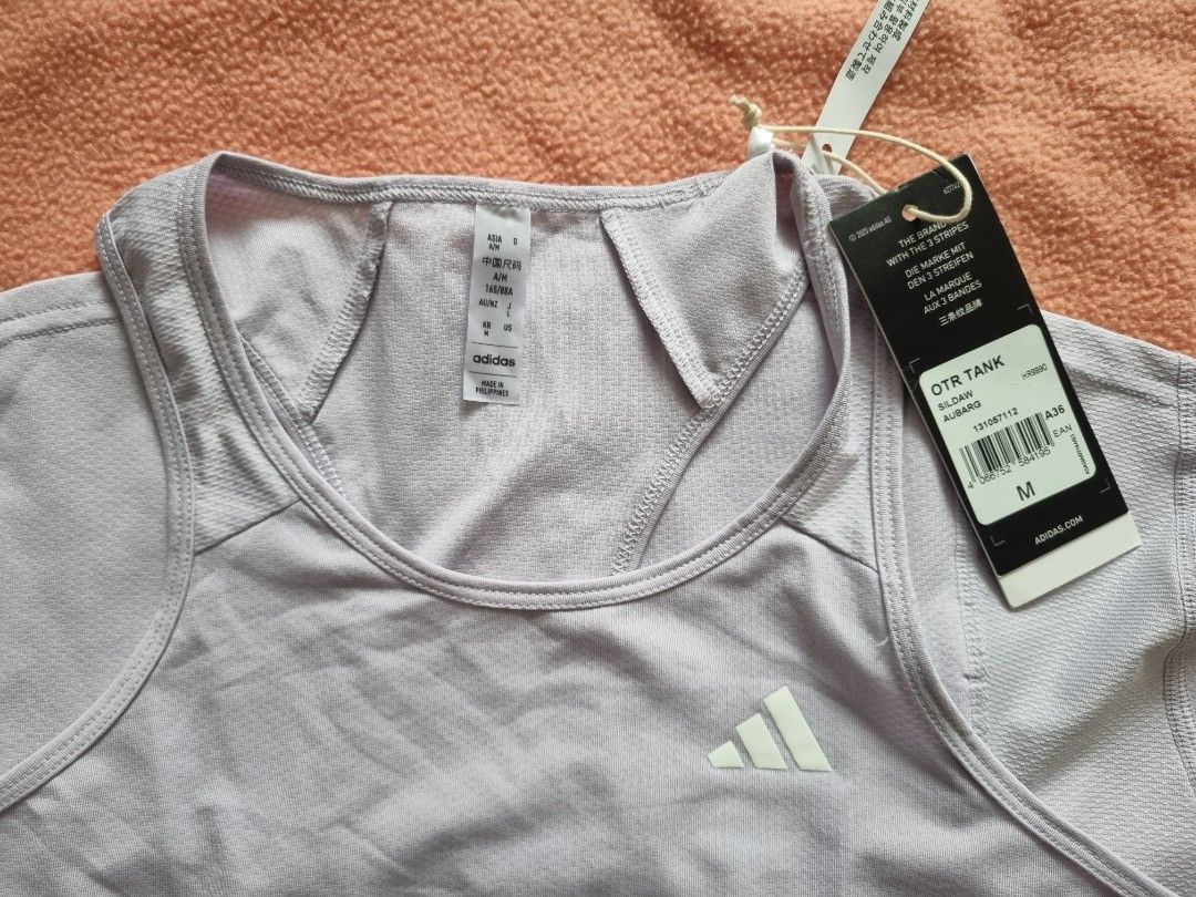 Adidas Own The Run Running Tank (Category: Activewear) located in Pasig City. Submitted by eeeaster (Listing ID 1218449856, Image 3). Description: Adidas Own The Run Running Tank Size: Medium but runs small [reason for selling, wrong size] Color: light lavender Brand new still with tags.