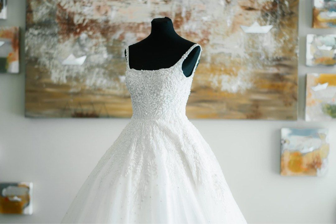 Wedding Gown (Category: Evening dresses & gowns) located in Pasig City. Submitted by thecoutlet (Listing ID 1218585441, Image 1). Description: Selling my wedding gown used last Dec 7 2022 from Mark Brides Manila. It is a square neckline with beads and rhinestones and long train. Ball gown type with light materials. Comfortable and easy to move in. Perfect for any wedding. Size specs: Bust - 33 inches Waist - 27 inches My height 5’3 Inclusions: Pe